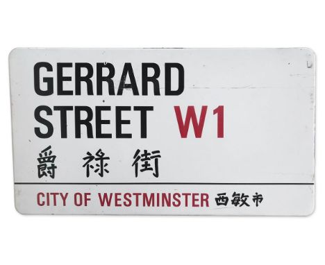 An enamelled iron street sign for Gerrard Street W1 Chinatown, City of Westminster with iconic black and red sans serif lette