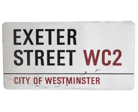 An enamelled iron street sign for Exeter Street WC2, City of Westminster with iconic black and red sans serif lettering first