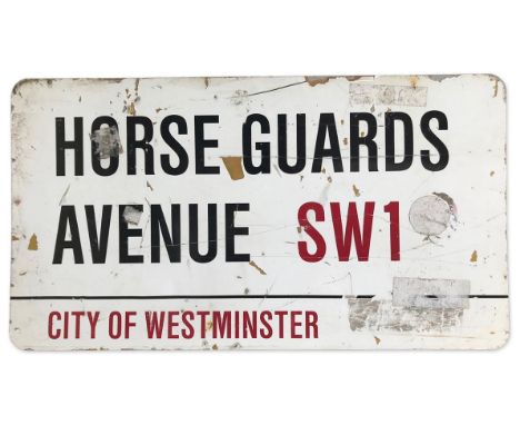 A metal street sign for Horse Guards Avenue SW1, City of Westminster with iconic black and red sans serif lettering first cre