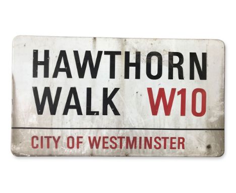An enamelled iron street sign for Hawthorne Walk W10, City of Westminster with iconic black and red sans serif lettering firs