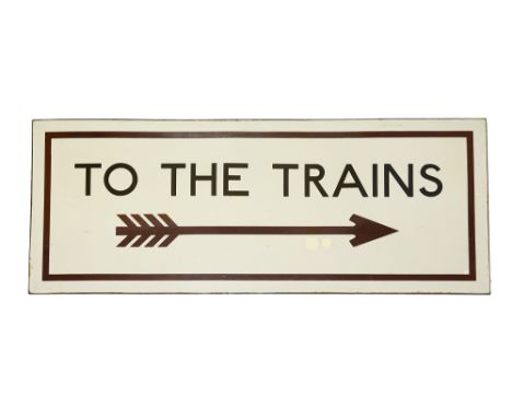 A London Underground enamel sign displaying 'TO THE TRAINS',black lettering on a white ground with maroon four-flighted arrow