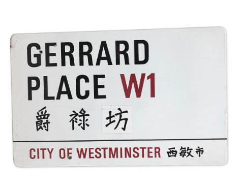 An enamelled iron street sign for Gerrard Place W1 Chinatown, City of Westminsterwith iconic black and red sans serif letteri