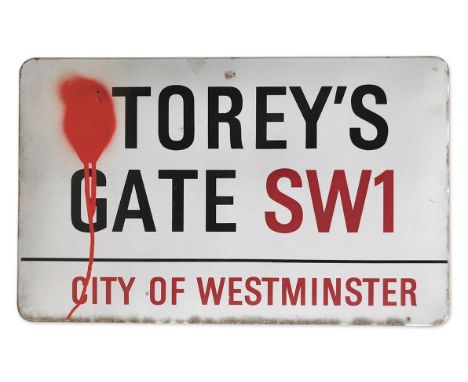 An enamelled iron street sign for Storey's Gate SW1, City of Westminster with iconic black and red sans serif lettering first