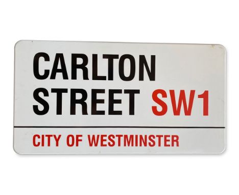 An enamelled iron street sign for Carlton Street SW1, City of Westminster with iconic black and red sans serif lettering firs