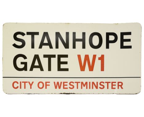 An enamelled iron street sign for Stanhope Gate W1,with iconic black and red sans serif lettering first created by Sir Misha 