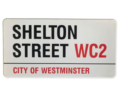 An enamelled iron street sign for Shelton Street WC2, City of Westminster with iconic black and red sans serif lettering firs