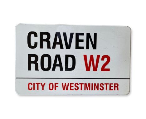 An enamelled iron street sign for Craven Road W2, City of Westminster with iconic black and red sans serif lettering first cr