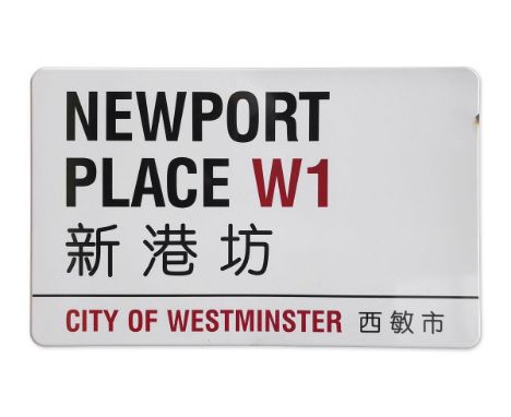 An enamelled iron street sign for Newport Place W1 Chinatown, City of Westminster with iconic black and red sans serif letter