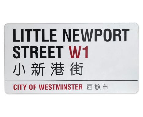 An enamelled iron street sign for Little Newport Street W1 Chinatown, City of Westminster with iconic black and red sans seri