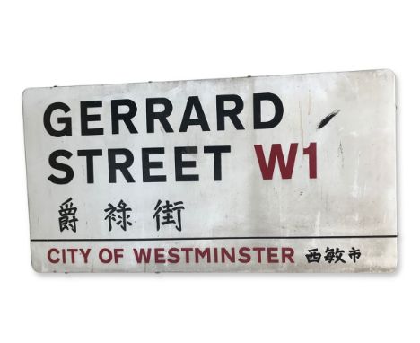 An enamelled iron street sign for Gerrard Street W1 Chinatown, City of Westminster with iconic black and red sans serif lette