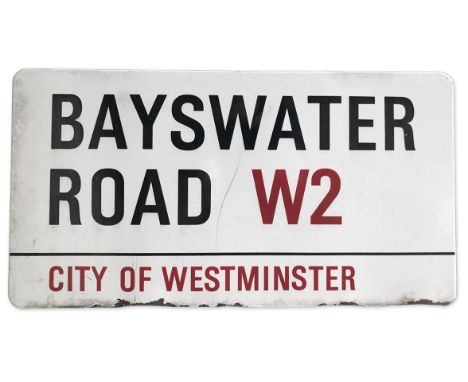 An enamelled iron street sign for Bayswater Road W2, City of Westminster with iconic black and red sans serif lettering first
