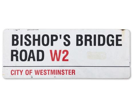 An enamelled iron street sign for Bishop's Bridge Road W2, City of Westminster with iconic black and red sans serif lettering