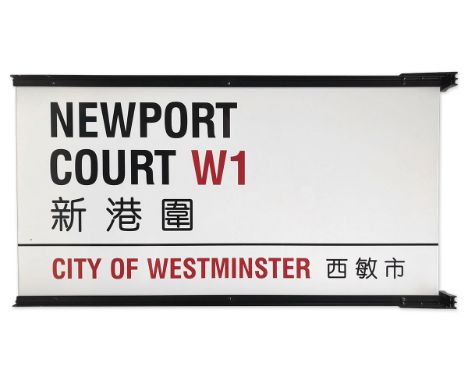 A double sided enamelled iron street sign on brackets for Newport Court W1 Chinatown, City of Westminster with iconic black a