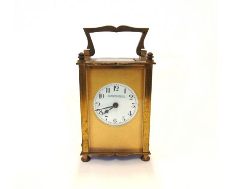 A BRASS CARRIAGE CLOCKthe circular white enamel dial with black Arabic numerals and marked 'Wm Bruford & Son Ltd / Exeter & E