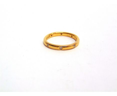 A 22 CARAT GOLD RING set with eight small brilliant cuts, totalling approximately 0.12 carats, finger size M, 3.6g gross, cas