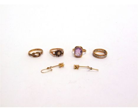 A 9 CARAT AMETHYST RING a 9 carat gold garnet and opal ring; a 9 carat gold knot ring; 8.3g gross; an eternity ring; and a pa