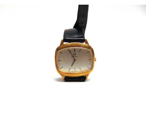 OMEGA, A GENTLEMAN'S 9 CARAT GOLD MECHANICAL WRISTWATCH on a strap, 1974 London import mark, the silvered TV shaped dial with