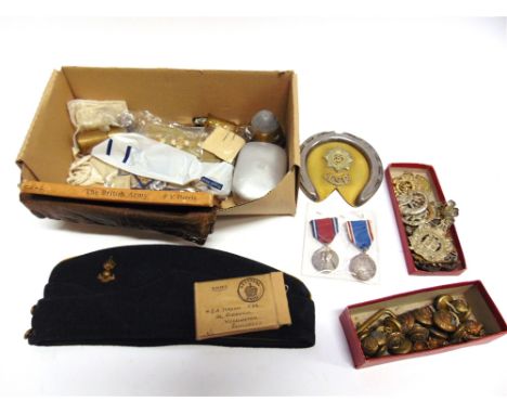 ASSORTED MILITARIA  comprising thirteen cap badges; a Royal Artillery forage cap; an Army Service Corps trench art style hors