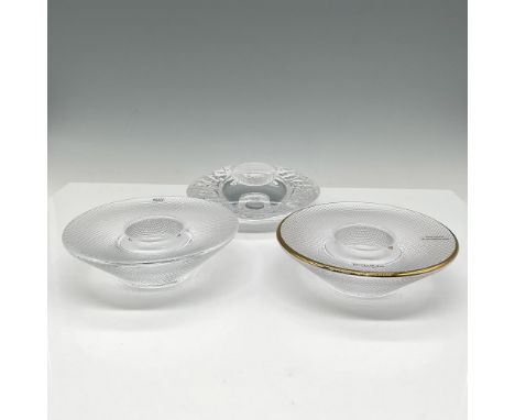 Clear crystal with ice and architectural design and one hand painted gilt rim on tea light holders. Kosta Boda mark. Issued: 