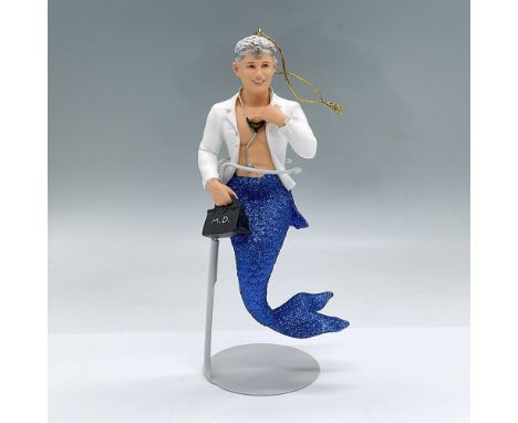 Dr. Fish and his medical bag are part of the Merman Collection. He has a white doctor's coat and blue sparkly fish tail. This
