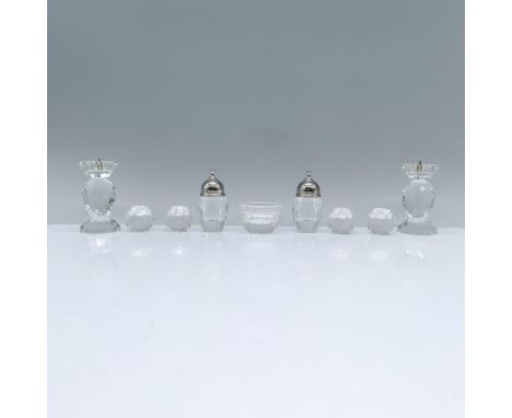 An exquisite crystal set, featuring 4 Swarovski Global candle holders, 2 Swarovski seasoning shakers, a Swarovski ring dish, 