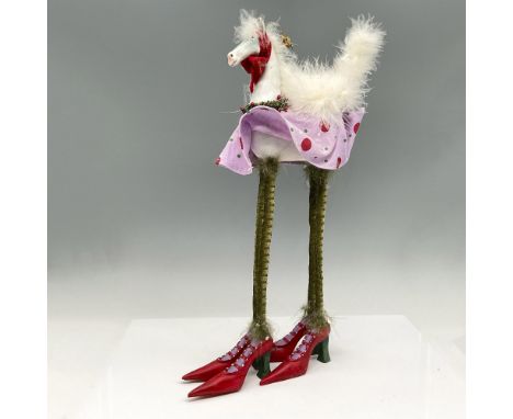 Colorful tall horse decorated for the holidays with red scarf, holly and leaf wreath, pink polka dot dress with long green le