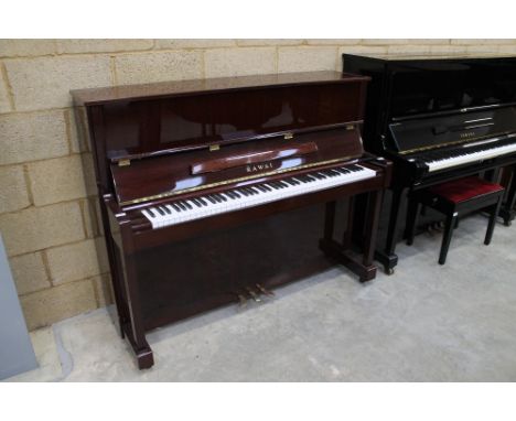 Kawai (c2003) A Model K-25E upright piano in a bright mahogany case. 