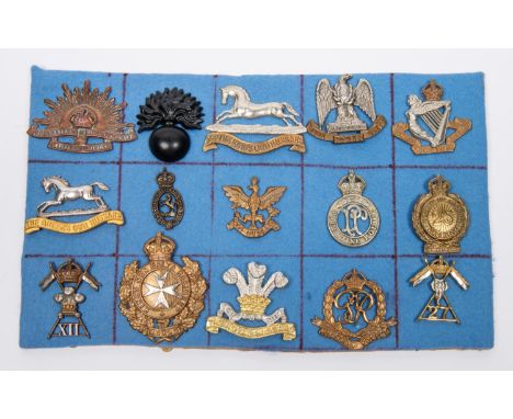 Fourteen military cap badges, including Royal Scots Greys, 8th Hussars, 12th Lancers, 27th Lancers, officer's silver and gilt