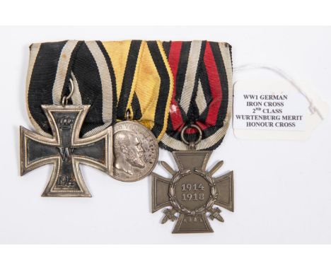 A German WWI medal trio: 1914 Iron Cross 2nd class, Wurttemberg silver Merit medal, and 1914-18 Honour Cross with swords, mou