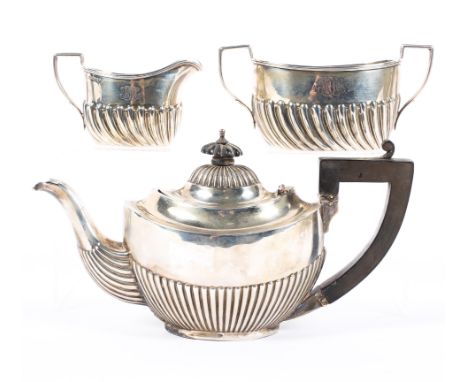 An early 20th century Silver batchelor's teapot and a similar cream jug and sugar bowl set, the latter being late Victorian, 