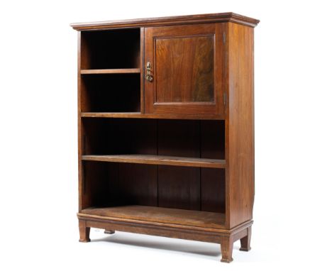 An Edwardian mahogany Sheraton style open bookcase with single cupboard opening to two drawers and eight compartments with ha