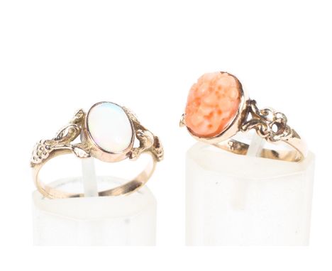 An unmarked yellow metal and opal doublet ring together with a 9ct gold pink coral set ring. 3.6g. Size N. 