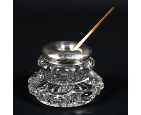 An Edwardian silver mounted glass inkwell together with a  silver and mother of pearl handled quill, the silver mount on the 