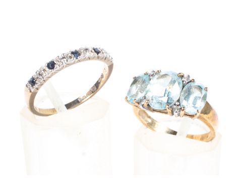 Two ladies 9ct gold gem set rings, one featuring three large blue stones with diamond accents, size K, the other a sapphire a