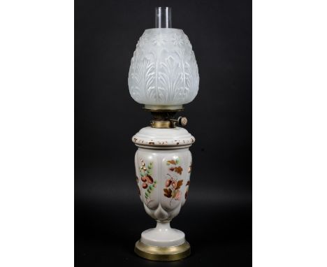 A Victorian ceramic painted decoration of foliage on oil lamp, with glass shade 60cm high