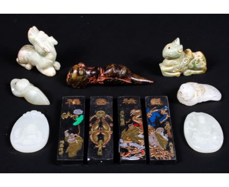 A collection of jade and stone figures, to include four animals of Archaic form, a reclining boy, two oval pendants, decorate
