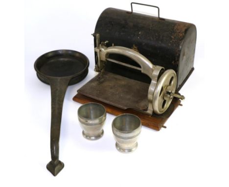 An Ideal mechanical sewing machine in tin box; an Indian bronze ladle or pan; and a pair of Danish pewter beakers 