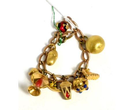A charm bracelet set with nine charms including an enamel fish 34.9g gross