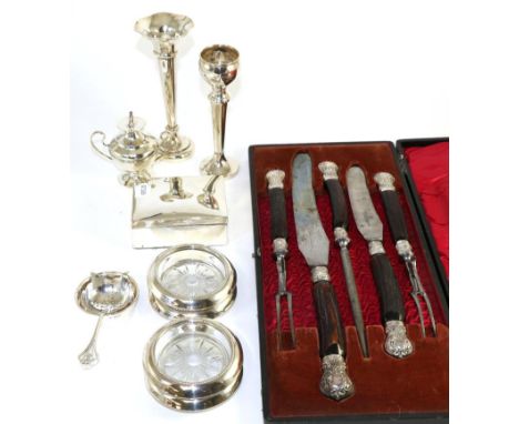 Two silver vases, a cigarette box, silver mounted glass butter dishes, a table lighter, a tea strainer and a silver collared 