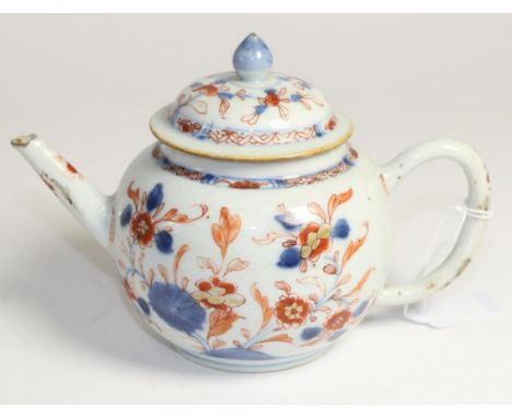 A Chinese Imari teapot and cover, 18th century, globular form painted with foliage, 13cm high Typical flakes to tip of spout 