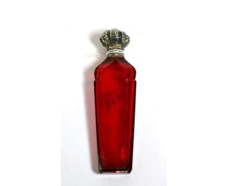 A Victorian cranberry glass scent flask with hinged silver coloured metal cover