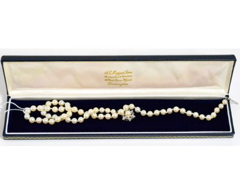 A cultured pearl necklace with a sapphire set 18ct white gold clasp29.2g gross. 50cm long 