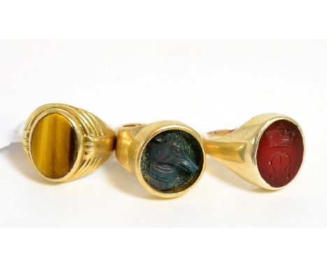 Three 9ct gold signet rings, two with carved hard stone matrix (3)Finger sizes R, R & L, 26.4g gross