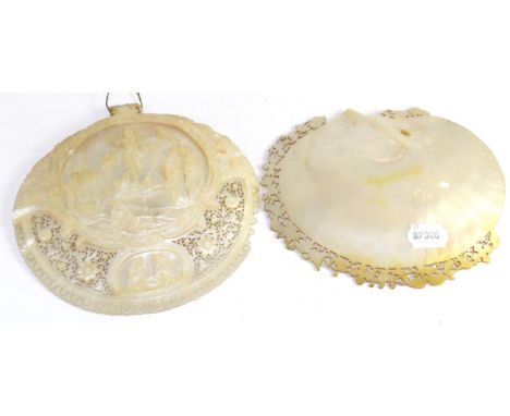 A mother of pearl shell, carved and pierced with a religious scene, together with another with carved border (2) (a.f)