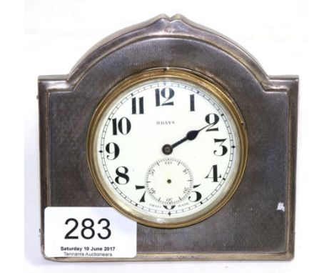 A silver mounted easel backed timepiece, Sheffield 1931, with engine turned decoration, 11cm wide (a.f.)
