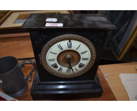 A Victorian Jet black metal cased mantle clock AF with ormolu and enamel face