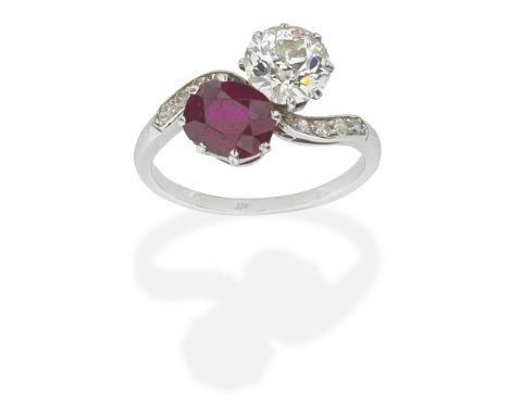 RUBY AND DIAMOND CROSSOVER RING, CIRCA 1930Oval-cut ruby and old brilliant-cut diamond, single-cut diamond shoulders, ruby ap