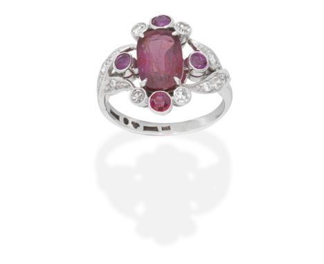 RUBY AND DIAMOND RINGThe cushion-shaped ruby, weighing 2.62 carats, with single-cut diamonds and circular-cut rubies, ring si