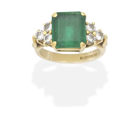 EMERALD AND DIAMOND RING, 1989Step-cut emerald, brilliant-cut diamonds, mounted in 18 carat gold, emerald approx. 3.65cts, UK