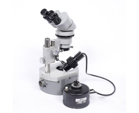 A Nikon electric illuminated binocular microscope with external voltage controller